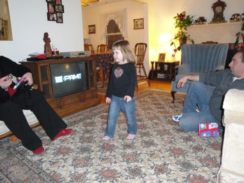 2000 Ford Crown Victoria - A family gathers in the living room, with a young girl standing near the television.