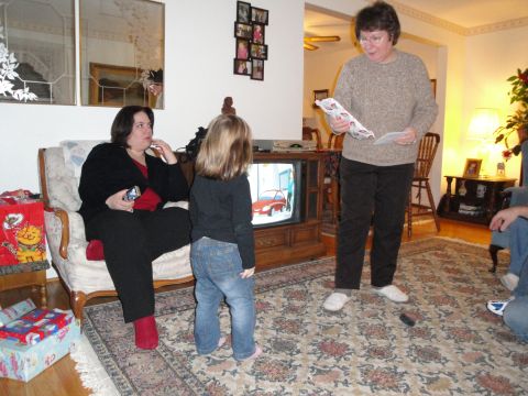 2000 Ford Crown Victoria - A family gathers in a living room, watching a cartoon car on an old television.