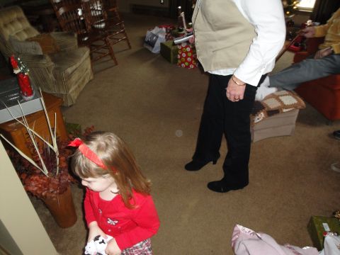2000 Ford Crown Victoria - A holiday gathering with a child and adults in a living room decorated with Christmas gifts.