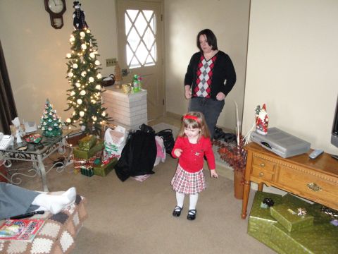 2000 Ford Crown Victoria - A festive living room scene with a decorated Christmas tree and people celebrating.