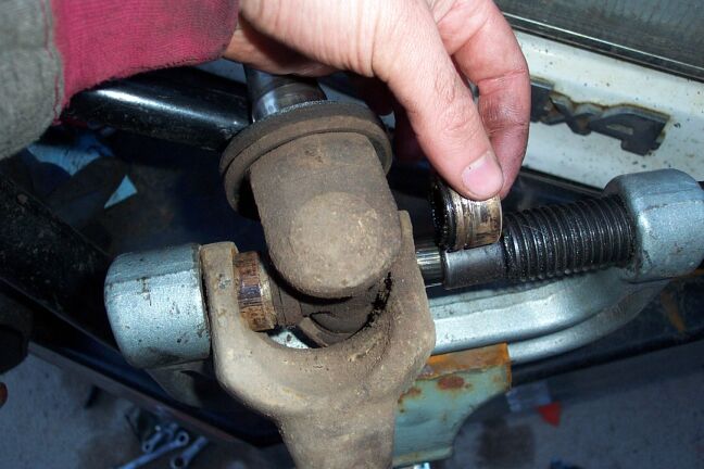 Here one cap is now out and I've flipped the axle around to press the other one out