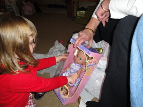 2000 Ford Crown Victoria - A young child excitedly opens a new doll as a gift.