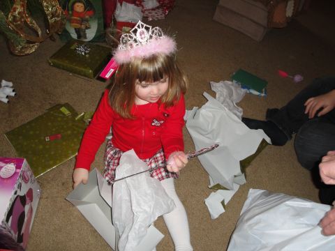 2000 Ford Crown Victoria - A child enjoys opening presents, possibly during the holidays.