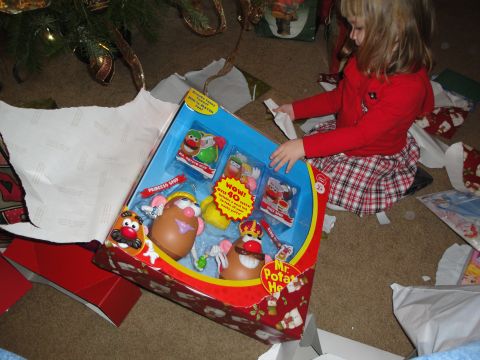 2000 Ford Crown Victoria - A child unwraps a Mr. Potato Head toy set on Christmas morning.