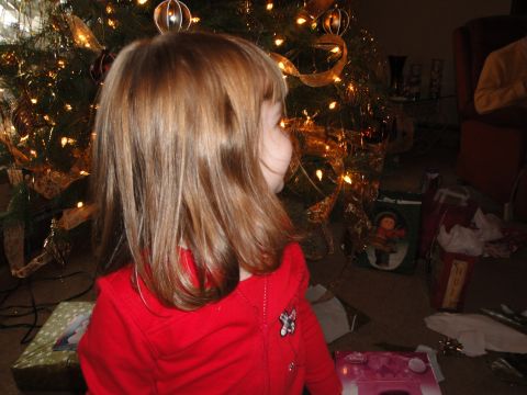 2000 Ford Crown Victoria - Child watches Christmas tree lights twinkle while presents wait to be opened.