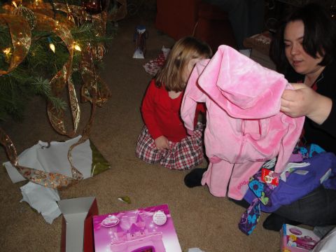 2000 Ford Crown Victoria - Christmas morning gift opening scene with a child and woman near a decorated tree.