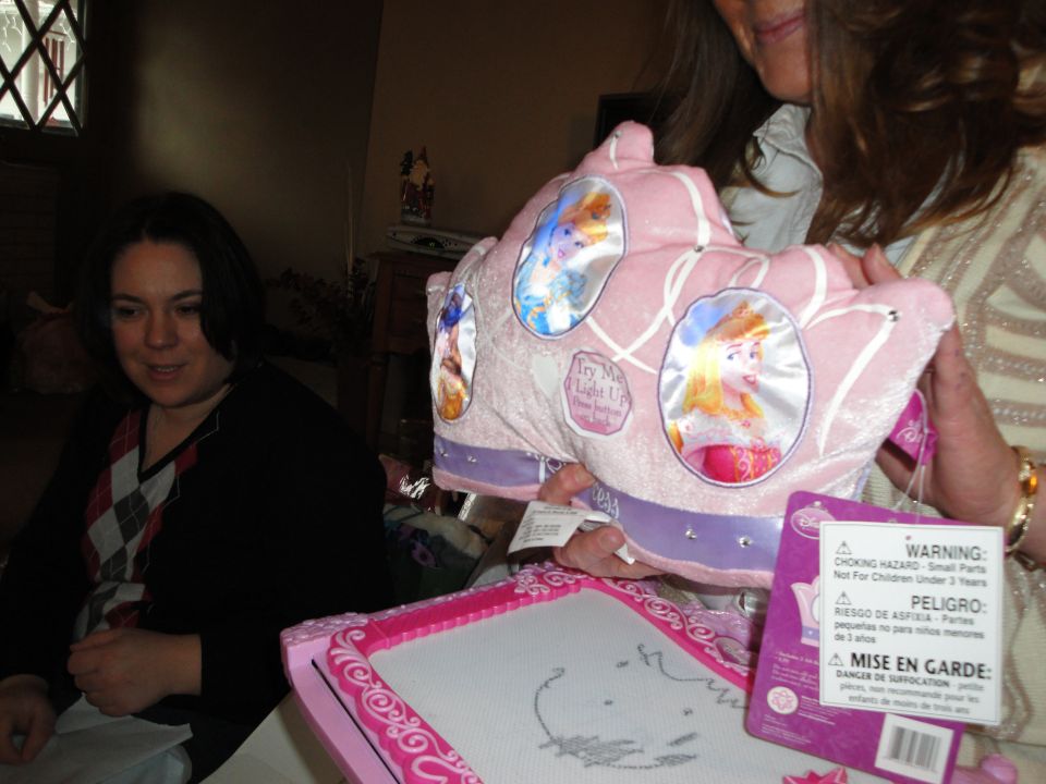 Pink toy carriage with Disney princesses and 'Try Me Light Up' button. Warning labels are attached