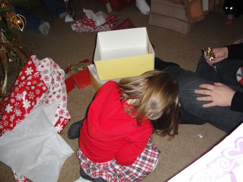 2000 Ford Crown Victoria - A child sits amidst wrapping paper and gifts on Christmas morning.