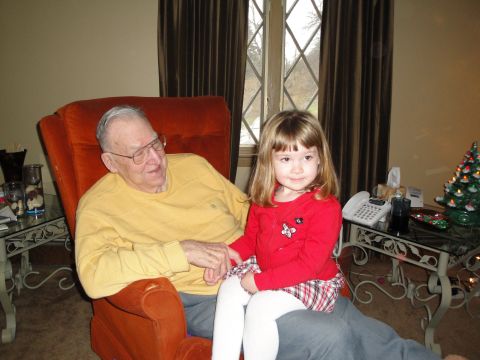 2000 Ford Crown Victoria - An elderly man and a young girl sit together indoors near a window and a Christmas tree.
