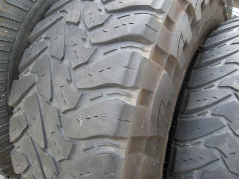 1986 Ford Bronco - Two off-road tires with deep tread blocks are shown side-by-side.