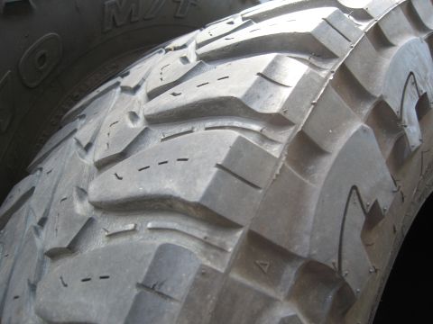 1986 Ford Bronco - A detailed view of aggressive tire tread patterns, suggesting off-road capability.