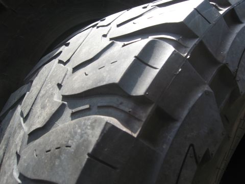 1986 Ford Bronco - A detailed view of the aggressive tread pattern on a tire, highlighting its off-road capabilities.