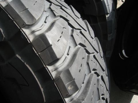 1986 Ford Bronco - Aggressive tread pattern on an off-road tire is visible in detail.