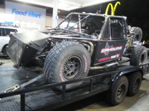 1986 Ford Bronco - This custom buggy is loaded onto a trailer in front of a Food Mart.