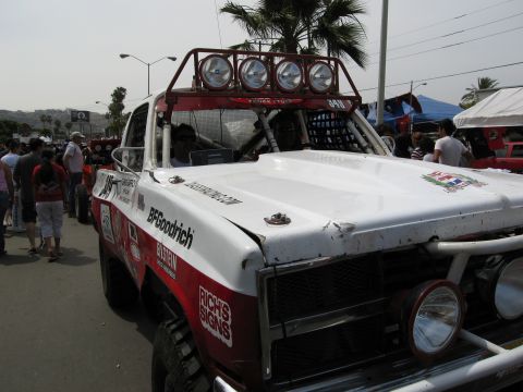 1986 Ford Bronco - Off-road race truck with multiple lights on the roof rack and BFGoodrich branding.
