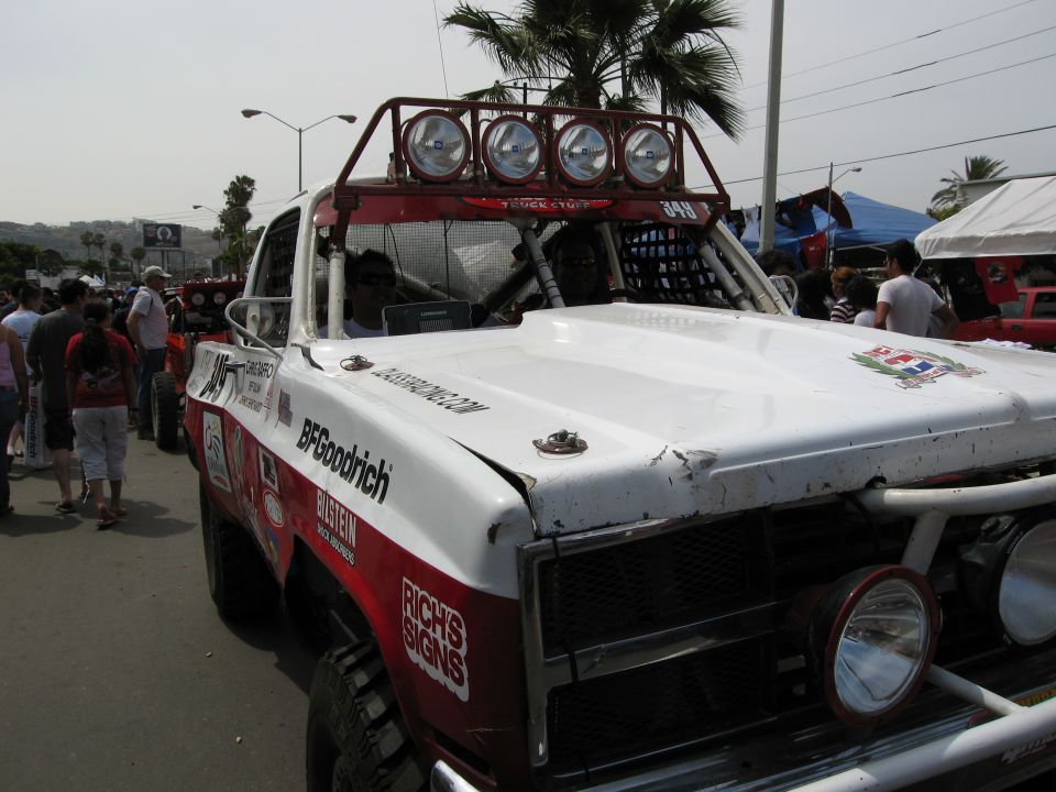 White off-road race truck with BFGoodrich and Bilstein decals, front grille and hood visible