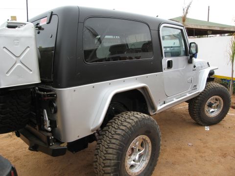 1986 Ford Bronco - This modified Jeep Wrangler is equipped for off-road adventures with its substantial tires and external fuel can.