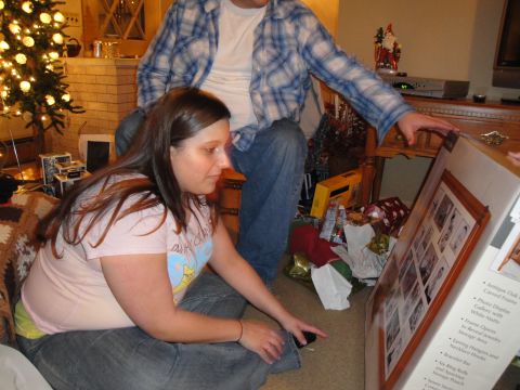 2000 Ford Crown Victoria - A couple unwraps a gift box containing a framed photo display during the holidays.