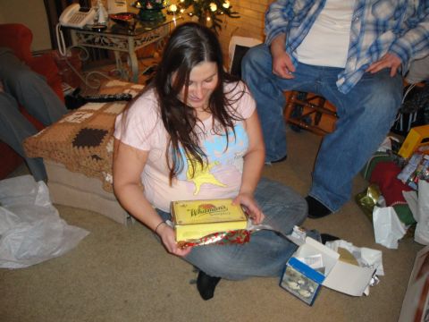 2000 Ford Crown Victoria - Woman opening a Whitman's chocolate box during a holiday gathering.