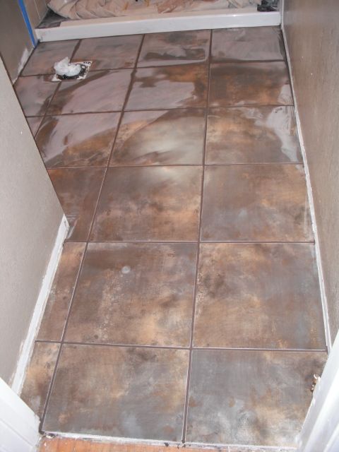 1991 Ford Bronco - The image shows a tiled floor in what appears to be a bathroom, with a shower base in the background.