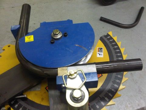 1996 Ford Bronco - A tube bender is used to shape metal tubing, with visible degree markings for precision.