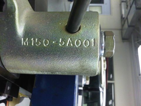 1996 Ford Bronco - A close-up view of a metal bracket with stamped alphanumeric characters.