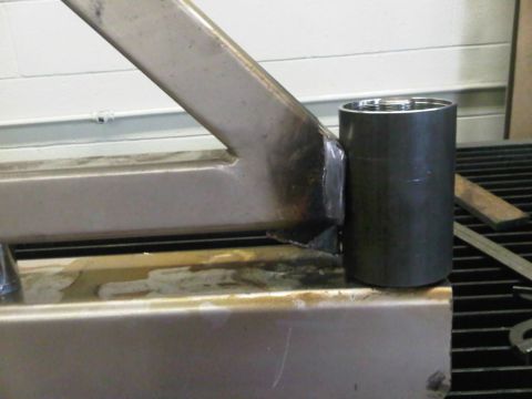 1996 Ford Bronco - A close-up view shows a metal bracket welded to a larger frame, with a cylindrical component attached.