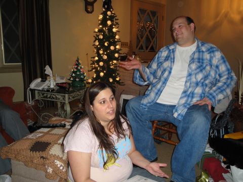 2000 Ford Crown Victoria - A festive holiday scene with two people conversing near a decorated Christmas tree.
