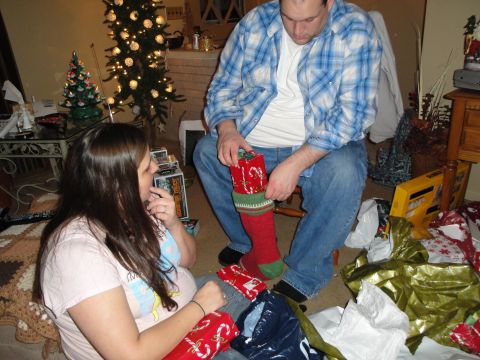 2000 Ford Crown Victoria - A couple opens Christmas presents in a festive living room setting.