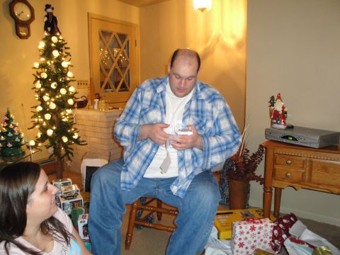 2000 Ford Crown Victoria - Christmas gathering with gifts being opened around a decorated tree.