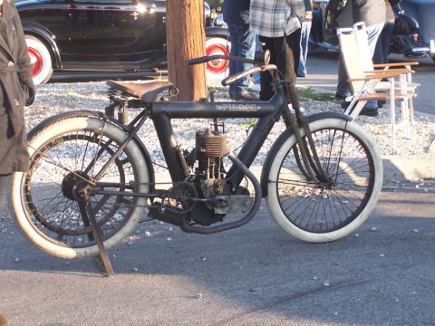 1990 Ford Bronco - Antique Pierce motorcycle parked outdoors with a vintage car visible behind it.