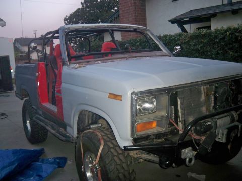 1985 Ford Bronco - This Ford Bronco is being restored, showing its roll cage and red seats with a primer gray front.