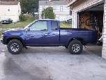 1988 Suzuki Samurai - Side view of a blue 1995 Nissan D21 pickup truck.