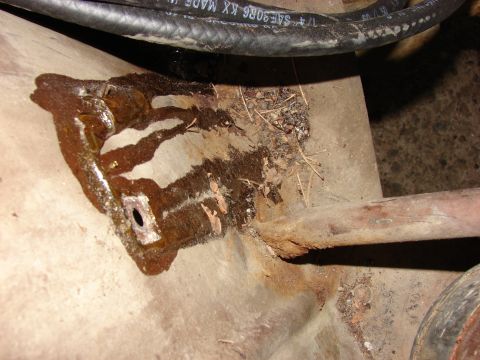 1979 Jeep CJ7 - Close-up of a rusted bracket and fuel line, indicating potential undercarriage issues.