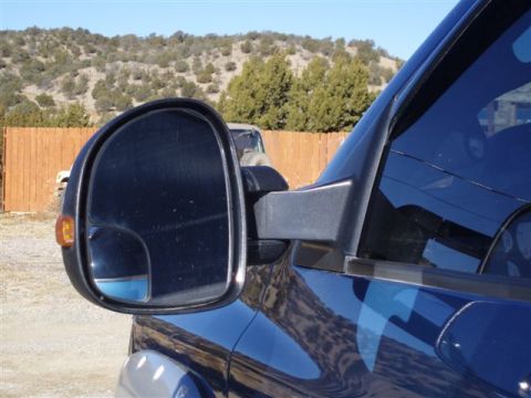 2007 Dodge 2500 - Close-up view of the driver's side mirror and door panel on a blue 2007 Dodge 2500.