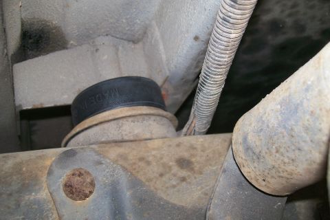 1992 Ford C-350 (Centurion Conversions) - Close-up view of an air spring lift kit component, with partial text reading 'MADE IN' visible on the black rubber part.