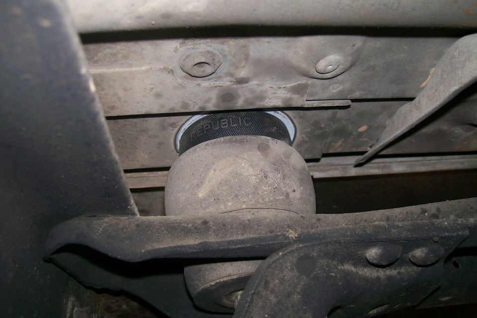 Close-up of an air spring with 'REPUBLIC' text on it, mounted to vehicle undercarriage