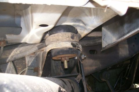 1992 Ford C-350 (Centurion Conversions) - Close-up of a body lift mount, showing the rubber isolator with visible text.