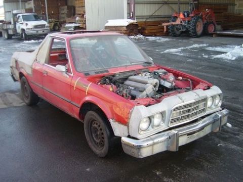 1972 Ford Ranchero - This red coupe utility has its engine exposed and appears to be undergoing repairs or modifications.