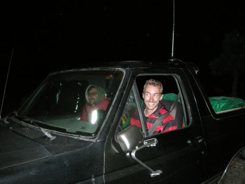 1991 Ford Bronco - Two men inside a 1991 Ford Bronco at night, possibly on an off-road trip.