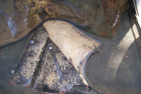 1992 Ford C-350 (Centurion Conversions) - A wrench rests on a heat shield and interior paneling, suggesting a repair or modification.