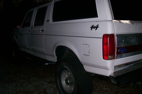 1992 Ford C-350 (Centurion Conversions) - Rear view of a white 4x4 SUV, showing the "4x4" decal on the side panel.