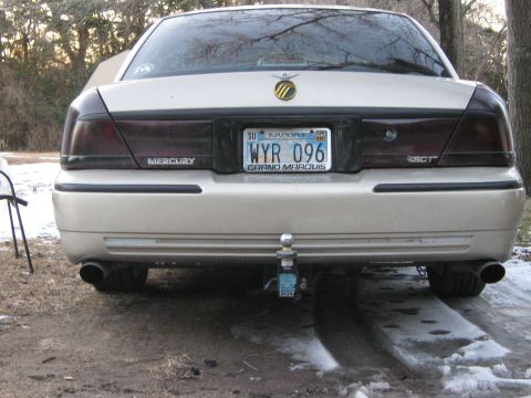2000 Mercury Grand Marquis - The rear of a 2000 Mercury Grand Marquis, tinted tail lights and a Kansas license plate.