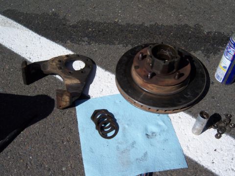 1971 International Scout II - The brakecaliper bracket, rotor, and hub. You can also see on the shop towel the axle nuts and washers that go inside the manual locking hu…
