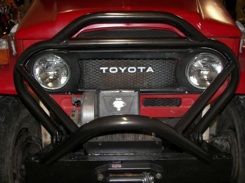 1990 Chevrolet Suburban - Front view of a Toyota Land Cruiser FJ40, equipped with a winch and brush guard.