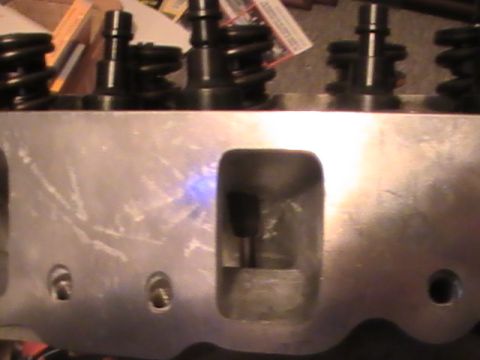 1971 Ford Mustang - This is a close-up view of an engine cylinder head, showing valve springs and ports.