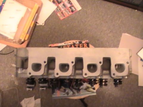 1971 Ford Mustang - A close-up view of an engine cylinder head, likely for a Ford Mustang, showing its internal components.