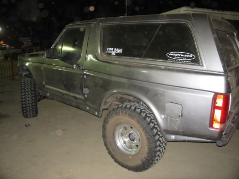 1986 Ford Bronco - This 1986 Ford Bronco, seen from the rear quarter, features off-road tires and a "FOR SALE" sticker on the window.