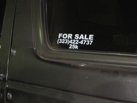 1986 Ford Bronco - This vehicle has a 'For Sale' sign on the window with a phone number and price listed.