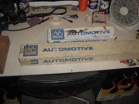 1981 Ford Bronco - Workbench setup with Moog Automotive parts boxes, tools, and a fan visible.